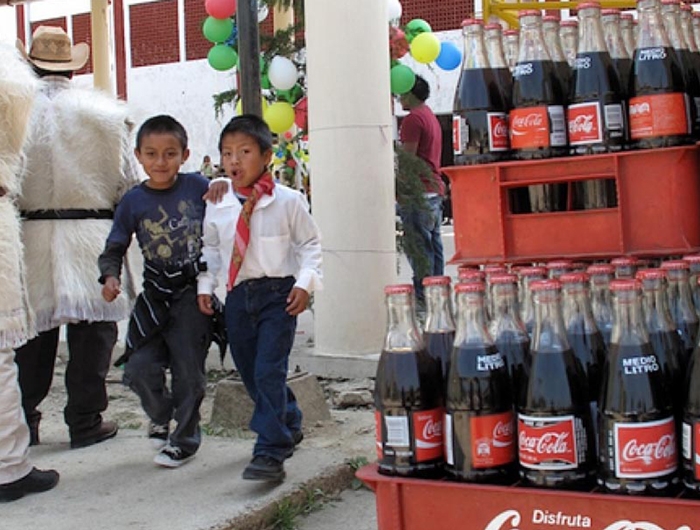 two boys walking past soda