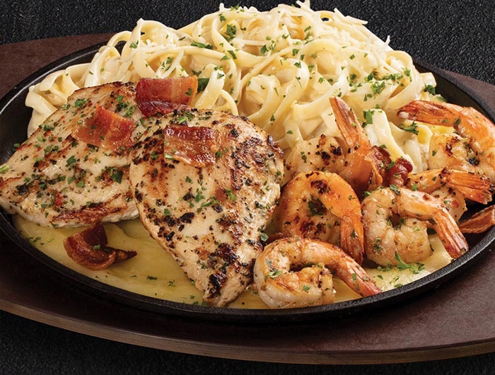 plate of chicken, shrimp, and pasta with melted cheese