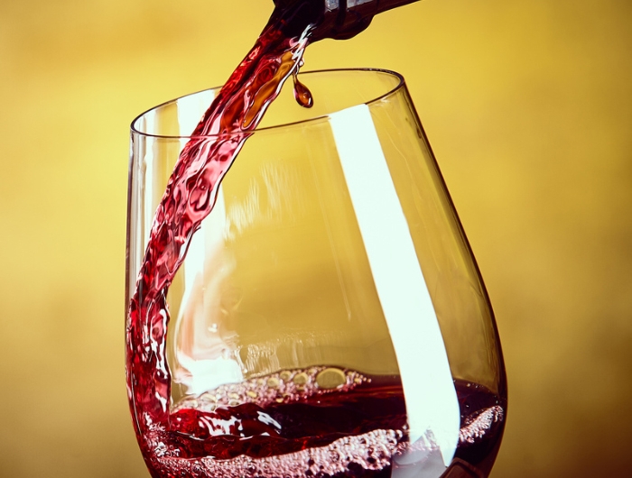 red wine pouring into a glass