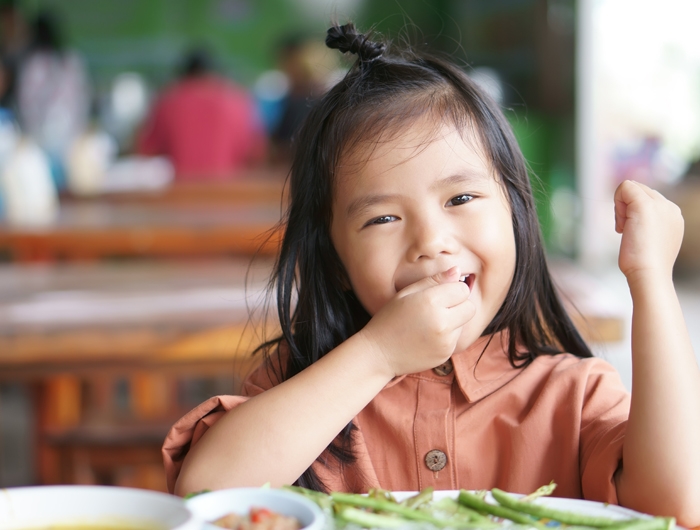 child eating a healthy school lunch