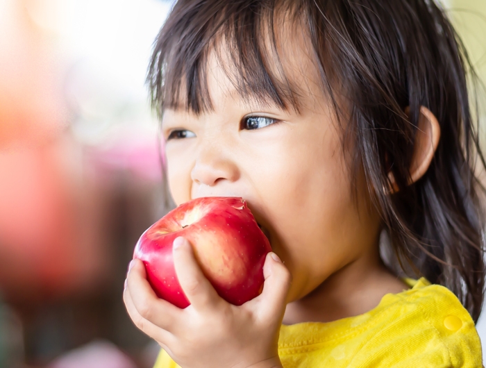 child eating an apple