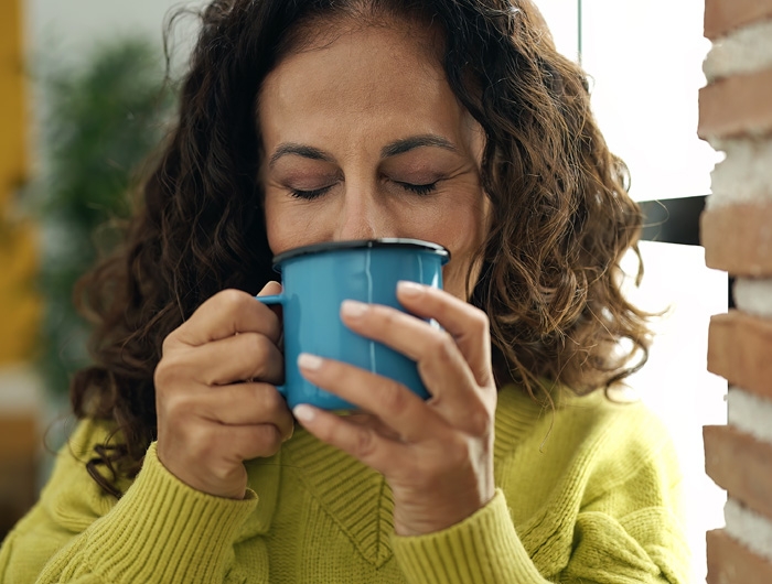 woman sipping from coffee mug