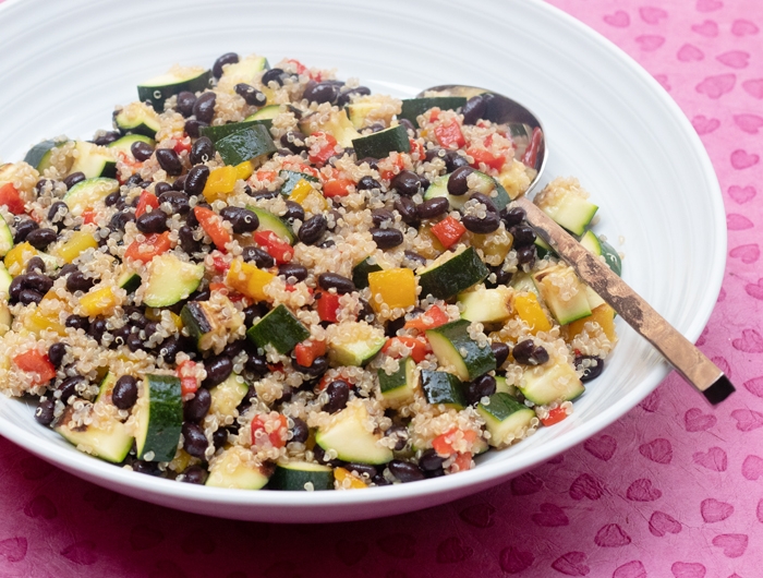 white bowl filled with black bean and quinoa and other vegetables