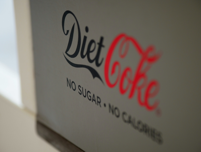 A sign that reads "Diet Coke: no sugar - no calories"
