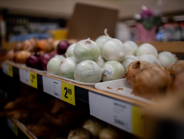Assorted onions on display in a supermarket