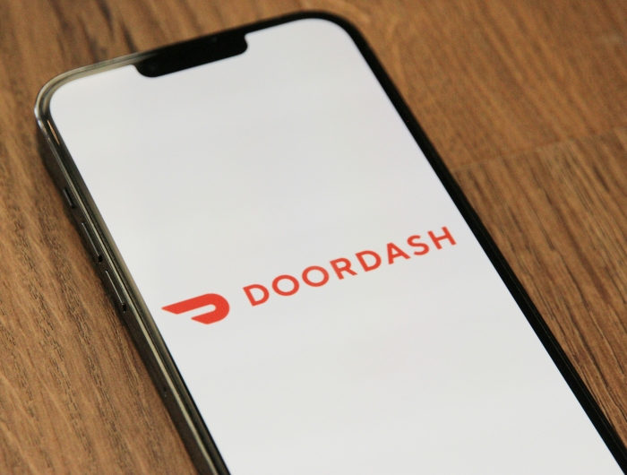 A mobile phone displaying the DoorDash loading screen