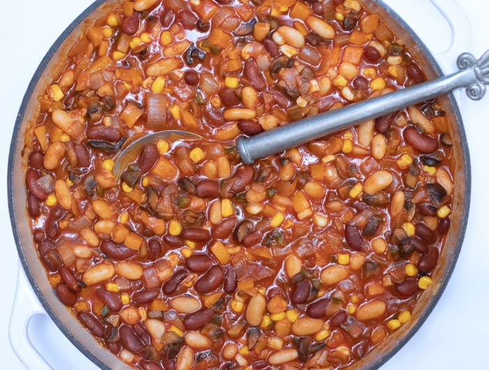 large pot with multi bean chili and a large silver spoon