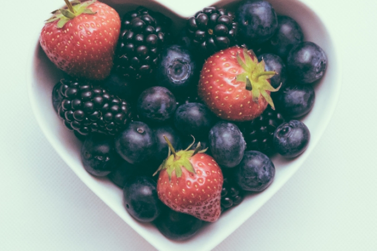 mixed berries in a heart-shaped bowl