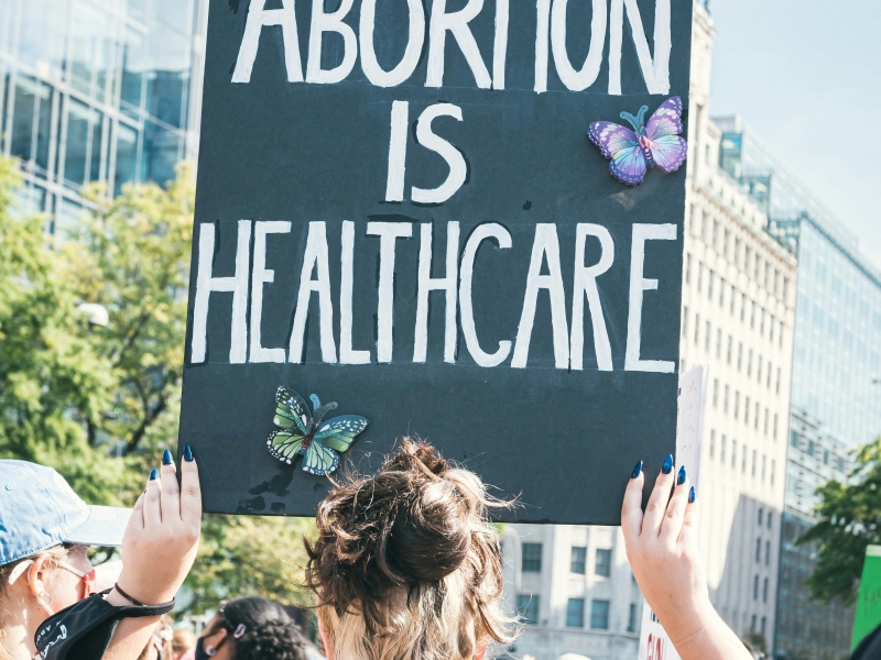 Protester carries sign reading "Abortion is Healthcare"