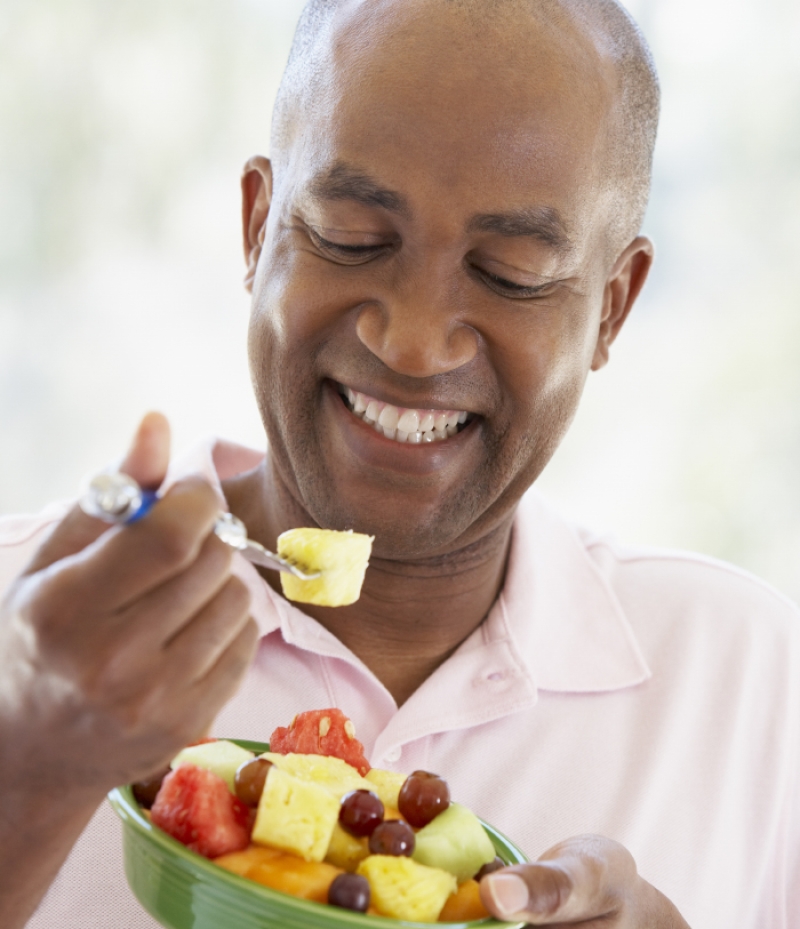 man eating fruit