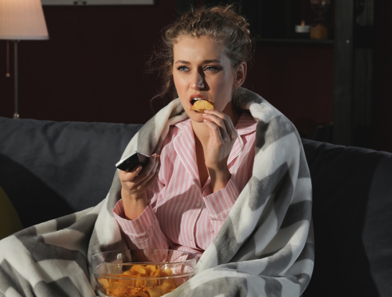 woman eating watching tv