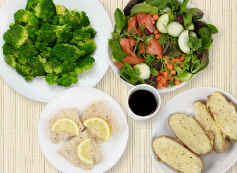 4 plates of cod, baked potato, salad, broccoli