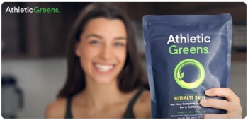 ad for Athletic Greens. Woman holding bag up to camera