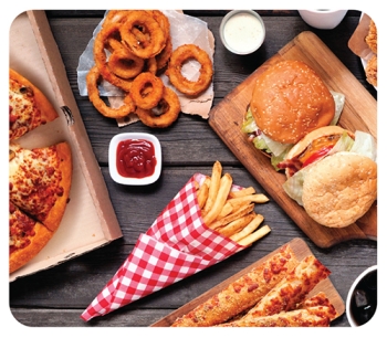 flat lay of pizza, burgers, fries and other ultra processed foods
