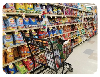 grocery cart in front of grocery chip aisle
