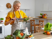 woman blending and chopping vegetables